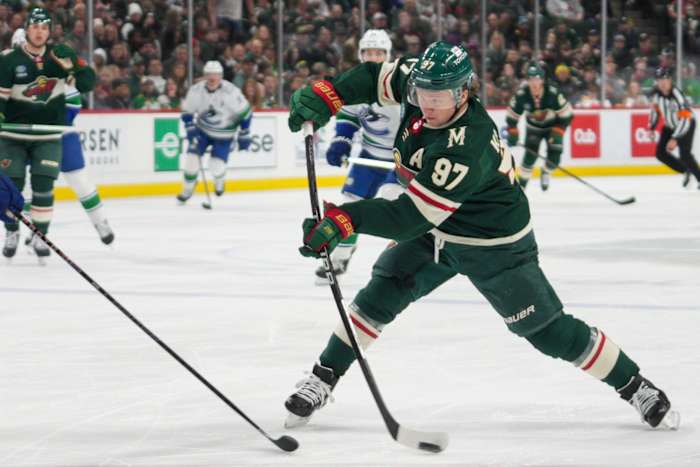 Feb 19, 2024; Saint Paul, Minnesota, USA; Minnesota Wild left wing Kirill Kaprizov (97) shoots against the Vancouver Canucks in the second period at Xcel Energy Center.